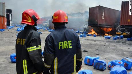 Firefighters assess the damage at the site of the fire.