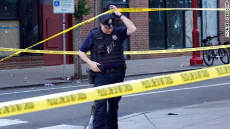 Philadelphia Police investigators work the scene Sunday of a deadly shooting on South Street.