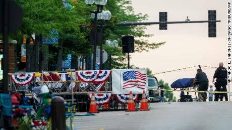 A body is transported from the scene of a mass shooting during the July 4th holiday weekend in Highland Park, Ill.