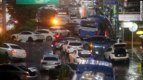 Abandoned vehicles fill the road in a flooded area during heavy rain in Seoul, South Korea, on August 8.