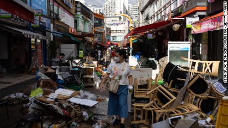 Debris piled up in front of flood-damaged stores at the Namsung Sagye Market in Seoul, South Korea, on August 10.