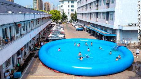 Children beat the heat at a gated community in Huzhou City in China's Zhejiang Province on August 12, 2022.