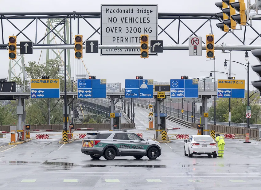 Police block lanes of traffic as both Halifax harbour bridges were closed in Dartmouth, N.S. on Saturday, Sept. 24, 2022. Post-tropical storm Fiona hit Nova Scotia in the early hours, knocking out power and disrupting travel across the region.