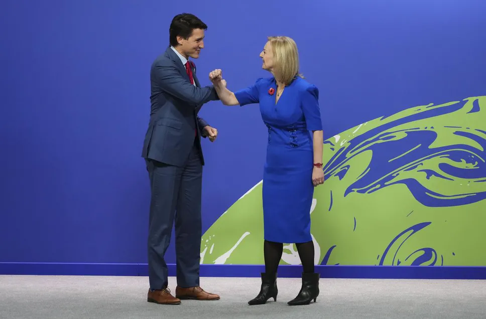 Prime Minister Justin Trudeau is greeted by UK Foreign Secretary Liz Truss as he arrives to COP26 in Glasgow, Scotland in November of last year.
