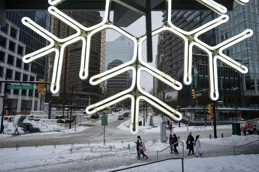Pedestrians in downtown Vancouver as freezing rain falls Friday.