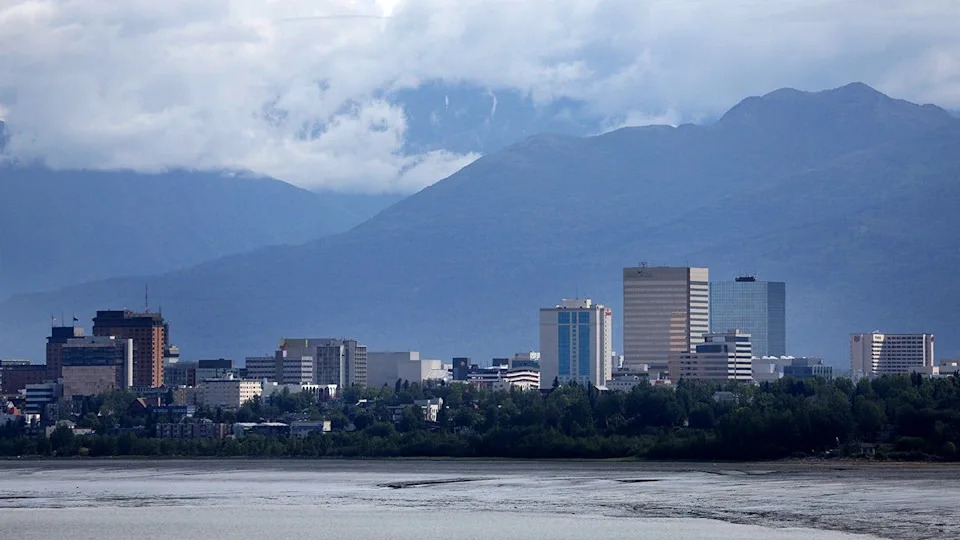 Downtown Anchorage skyline with mountains in the background.