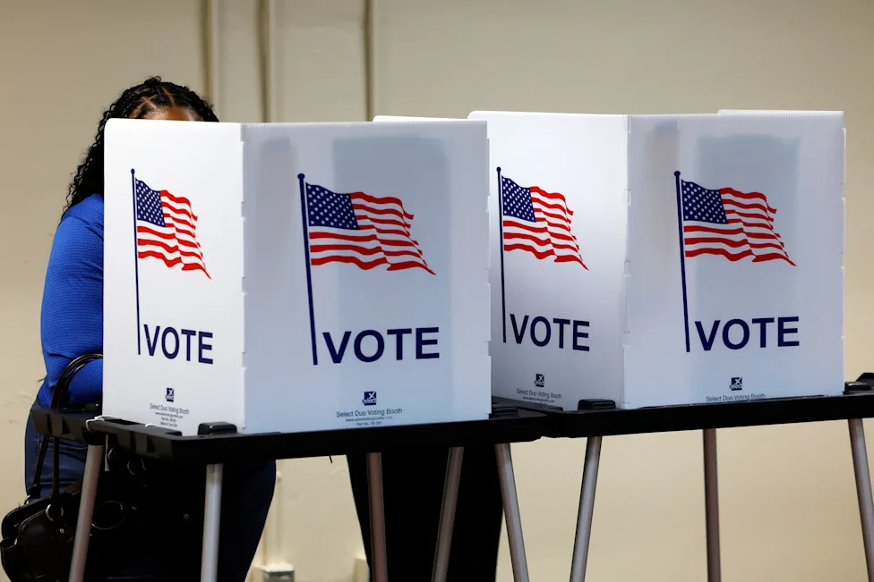 Voters cast their in-person early ballot for the 2024 general election