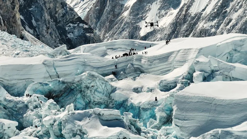 Snapshot taken from a video shows a DJI drone flying over Khumbu Icefall during a delivery test on Mount Qomolangma from the Nepali side, April 30, 2024. DJI has successfully completed the first-ever drone delivery tests on Mount Qomolangma from the Nepali side, paving the way for facilitating high-altitude mountaineering, emergency rescue and environmental protection operations, the Chinese drone maker announced Wednesday.  A DJI FlyCart 30 was used in the April tests, during which three oxygen bottles and 1.5 kg of other supplies were flown from the Base Camp (at an altitude of 5,364 meters) to Camp 1 (at about 6,000 meters) of the world's highest peak, and trash was carried down on the return trip. (Photo by Xinhua via Getty Images)
