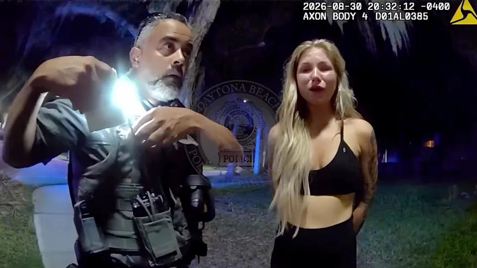 Elizabeth Boucher speaks with a Daytona Beach police officer before her arrest