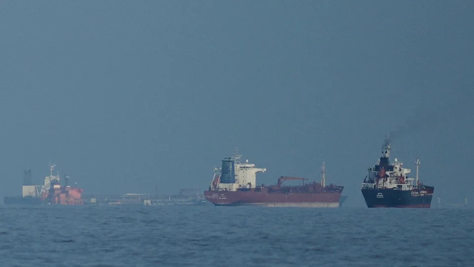 Oil tankers and cargo ships lining up in the Strait of Hormuz.