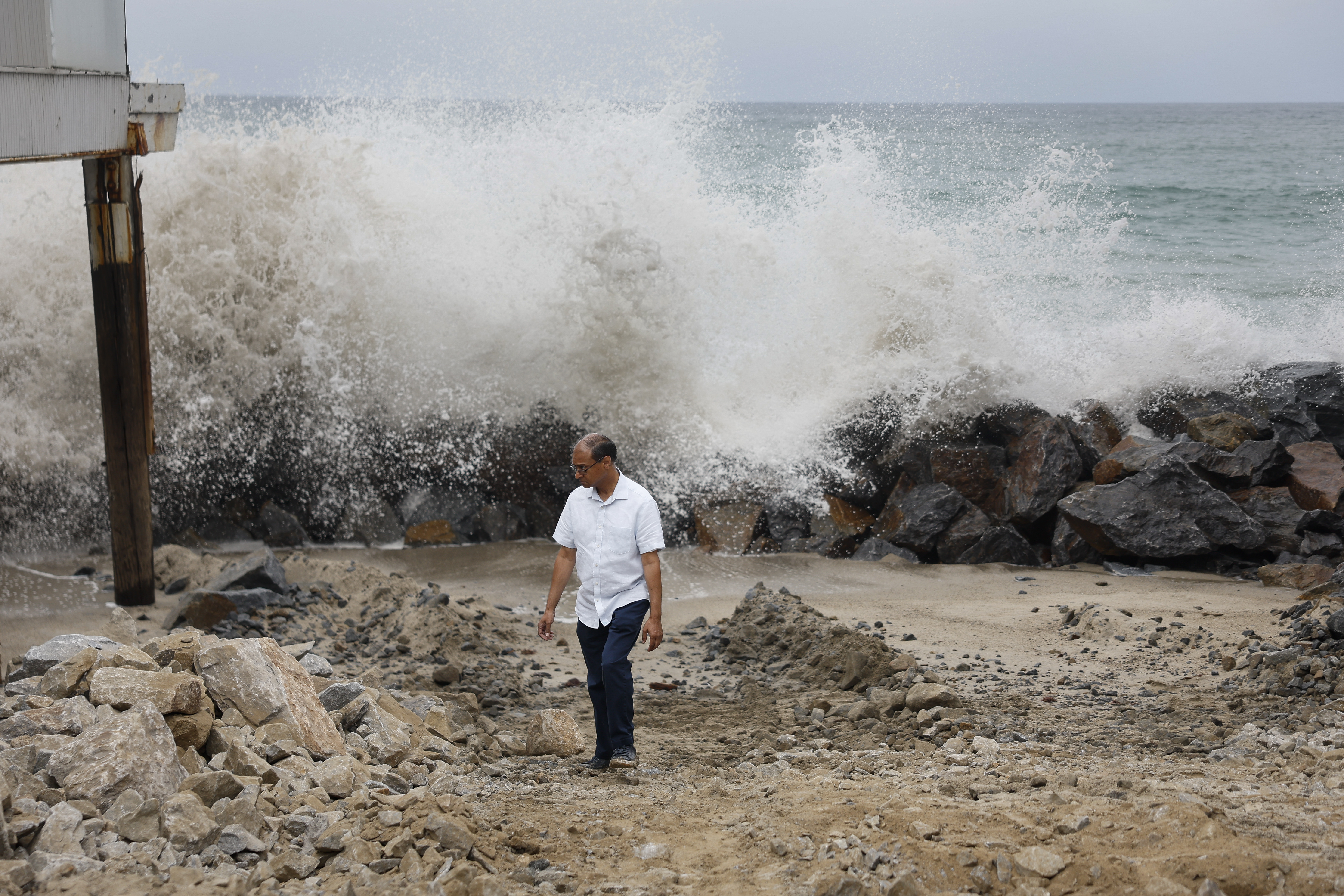Waves destroyed the seawall in front of Shalesh Gupta's house. The doctor only has about $250,000 in flood insurance — not enough to cover the loss of his home. - (Caroline Brehman/For The Washington Post)