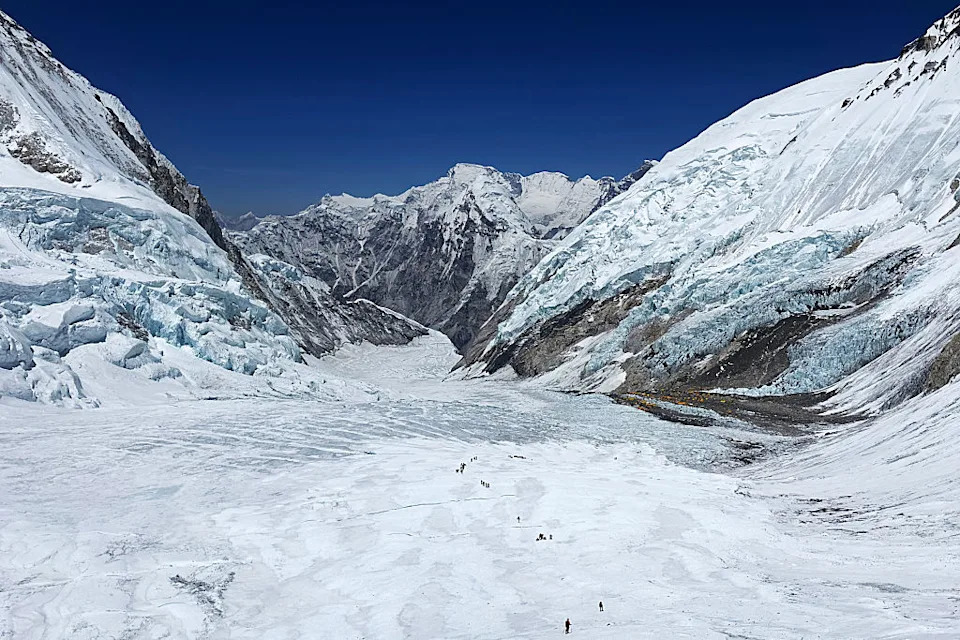 This photograph taken on May 3, 2024 shows mountaineers at the Khumbu Glacier during their ascend to Mount Everest's summit, in Nepal. A 54-year-old Nepalese climber known as "Everest Man" reached the peak of the world's highest mountain for a record 30th time on May 22, 2024, three decades after his first summit. (Photo by Tsering Pemba Sherpa / AFP via Getty Images)