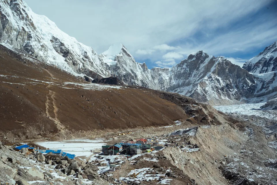 GORAKSEHP, NEPAL - OCTOBER 12: A view of Gorakshep with the Khumbu glacier on the right on October 12, 2024 in Gorakshep, Sagarmatha Region, Nepal. The growing popularity of trekking in Nepal has resulted in various forms of pollution spoiling the fragile ecosystem. Gorakshep is the last human settlement on the Nepal side before trekkers arrive at Everest Base Camp just 3.5km away. Here, waste management issues due to trekking tourism are apparent with plastic bottles and debris from lodges and restaurants dumped just meters from the town centre. Early in the autumn trekking season, Everest Base Camp itself also shows signs of waste mismanagement. (Photo by Mailee Osten-Tan/Getty Images)