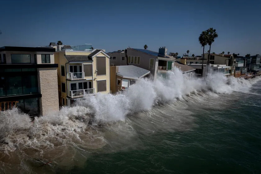 Waves continue to hit homes on Tuesday, Oct. 13, 2026 in Long Beach, CA.